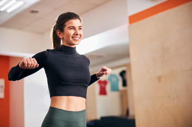 Copy-space photo of athletic brunette lady having an extensive warm-up before her workout
